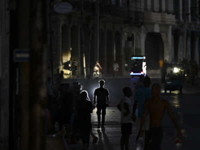 People walk on a street during a blackout in Havana on May 13, 2026.