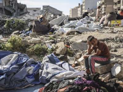 A Palestinian boy sits at the site of an overnight Israeli military strike on structures and tents housing displaced families, killing ten Palestinians, in Gaza City on May 28, 2026.