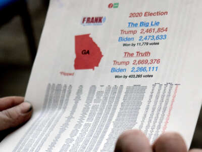 A man attending a vote canvassing event hosted by Angela Rubino in Rome, Georgia, on January 22, 2022, brought paperwork that he said proves massive election fraud occurred in Georgia. Rubino is a conspiracy theory believer who stands with Republicans who espouse the belief that the 2020 election was stolen from Donald Trump.