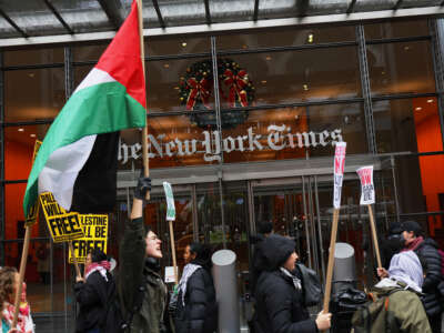Demonstratos gather outside of The New York Times building to protest the newspaper’s coverage of the genocide on December 11, 2023, in New York City.
