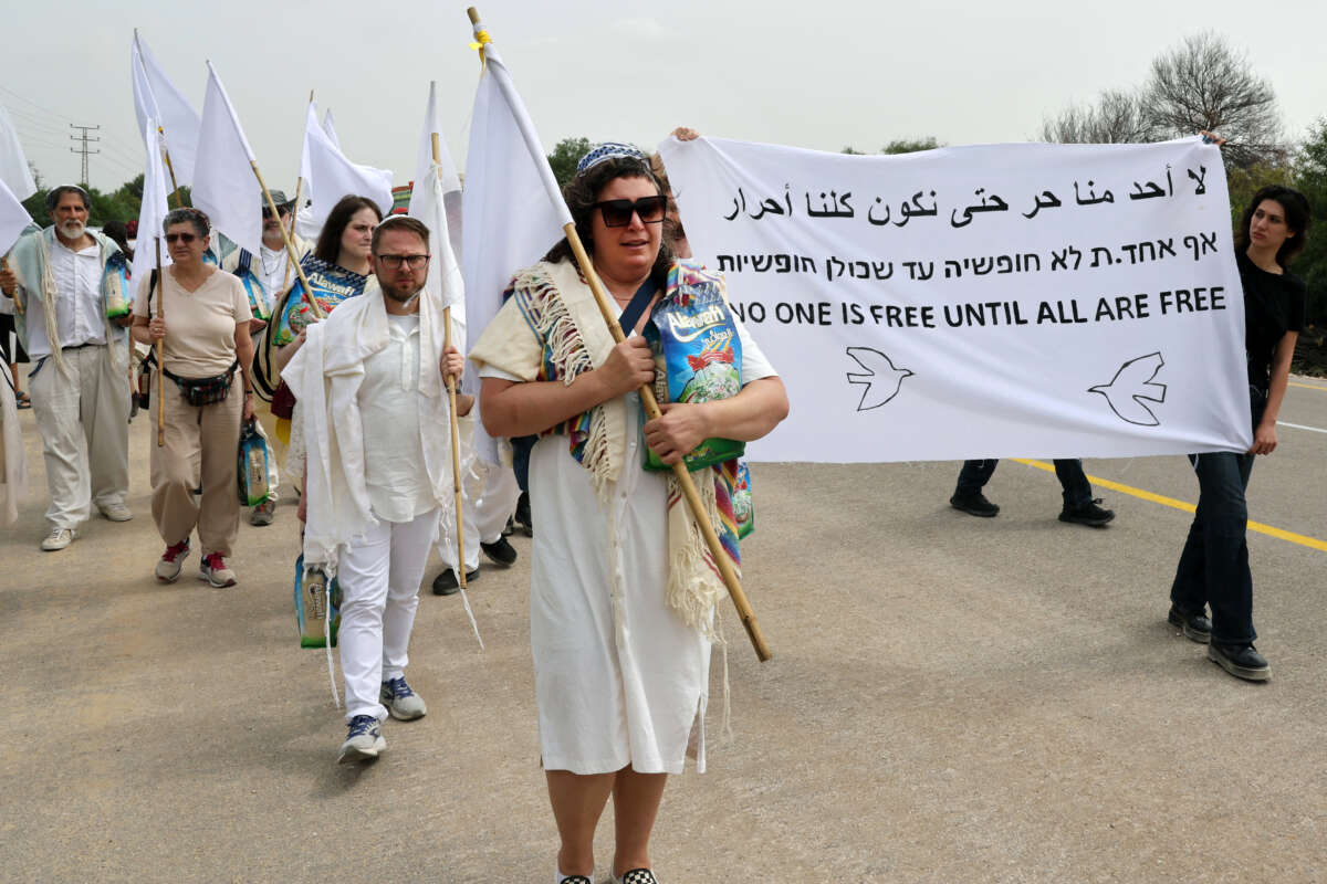 U.S. and Israeli rabbis and rabbinical students from the group Rabbis for Ceasefire, joined by peace activists, march toward the Erez crossing on the border with northern Gaza Strip symbolically carrying bags of rice and white flags, to call for a permanent ceasefire on April 26, 2024.