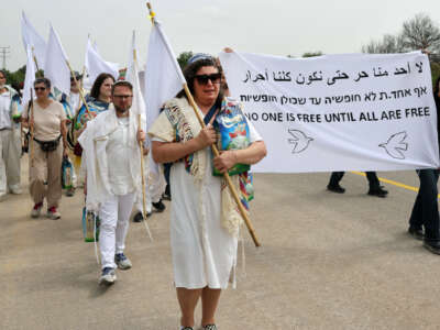 U.S. and Israeli rabbis and rabbinical students from the group Rabbis for Ceasefire, joined by peace activists, march toward the Erez crossing on the border with northern Gaza Strip symbolically carrying bags of rice and white flags, to call for a permanent ceasefire on April 26, 2024.