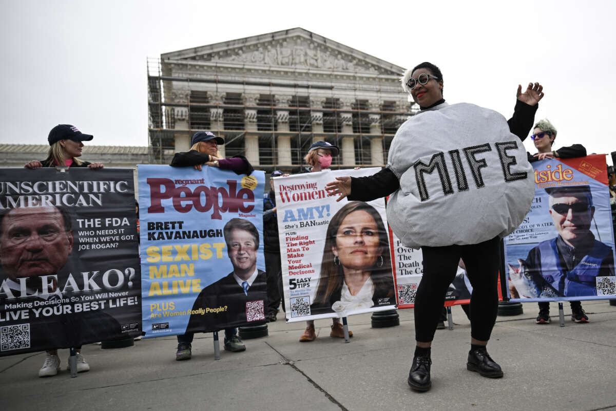 A woman dressed as a mifepristone pill dances with supporters of Planned Parenthood and pro-choice activists during a rally outside the Supreme Court on April 2, 2025, in Washington, D.C.