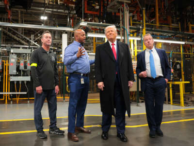 President Donald Trump talks with Ford River Rouge Plant Manager Corey Williams (second from left), and Executive chair of Ford Motor Company Bill Ford Jr. (right) as they tour the Ford River Rouge Complex, on January 13, 2026 in Dearborn, Michigan.