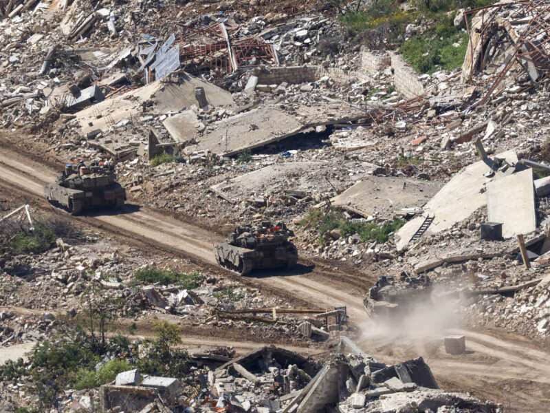 Israeli tanks drive along the road between destroyed houses in southern Lebanon near the border with Israel, on April 29, 2026.