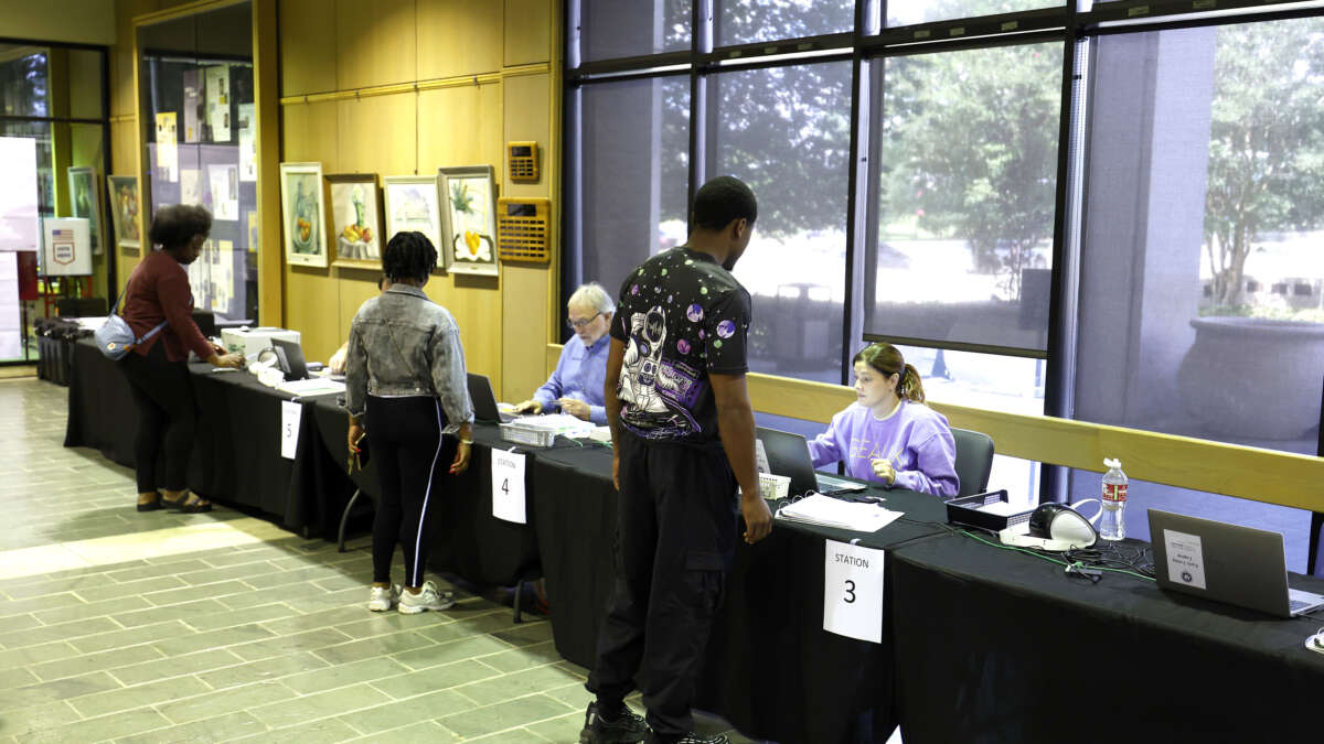 Voters check in before casting their ballots on the first day of early voting at the Louisiana State Archives on May 2, 2026, in Baton Rouge, Louisiana.