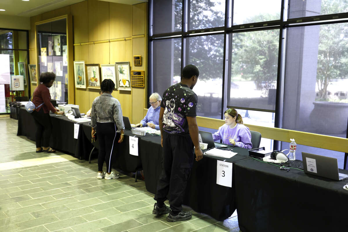 Voters check in before casting their ballots on the first day of early voting at the Louisiana State Archives on May 2, 2026, in Baton Rouge, Louisiana.
