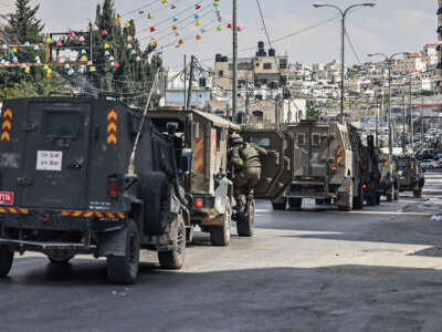 Israeli forces patrol in their vehicles during a military raid at the Qalandia refugee camp, south of the city of Ramallah, in the Israeli-occupied West Bank, on May 6, 2026.