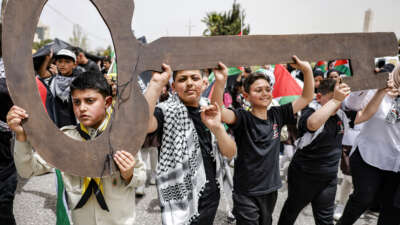 Boys march with a figure depicting a traditional key symbolizing the homes that Palestinians evacuated in 1948 during the Nakba, their 1948 displacement by Zionist militias during the creation of Israel, during a march commemorating the 78th anniversary of the catastrophic event in the city of Ramallah in the occupied West Bank, on May 12, 2026.