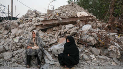 Two women visit the ruins of Al-Shajara Al-Tayyiba School on May 13, 2026, in Tehran, Iran.