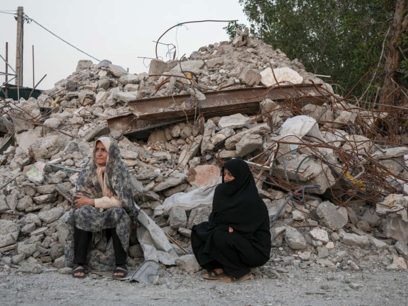 Two women visit the ruins of Al-Shajara Al-Tayyiba School on May 13, 2026, in Tehran, Iran.