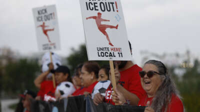 Union workers hold signs as they rally outside of SoFi Stadium ahead of the 2026 FIFA World Cup to demand investigations into FIFA’s security and worker accreditation policies, while also calling for protections against immigration enforcement activity and AI-related job displacement at the stadium, on May 18, 2026, in Inglewood, California.
