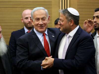 Israeli Prime Minister Benjamin Netanyahu (L) greets National Security Minister Itamar Ben-Gvir, during a media briefing ahead of a vote on the national budget, on May 23, 2023, at the Israeli parliament.