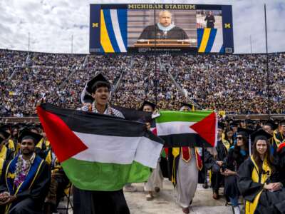 Students protest in support of Palestine during the University of Michigan’s Spring Commencement ceremony on May 4, 2024 at Michigan Stadium in Ann Arbor, Michigan.