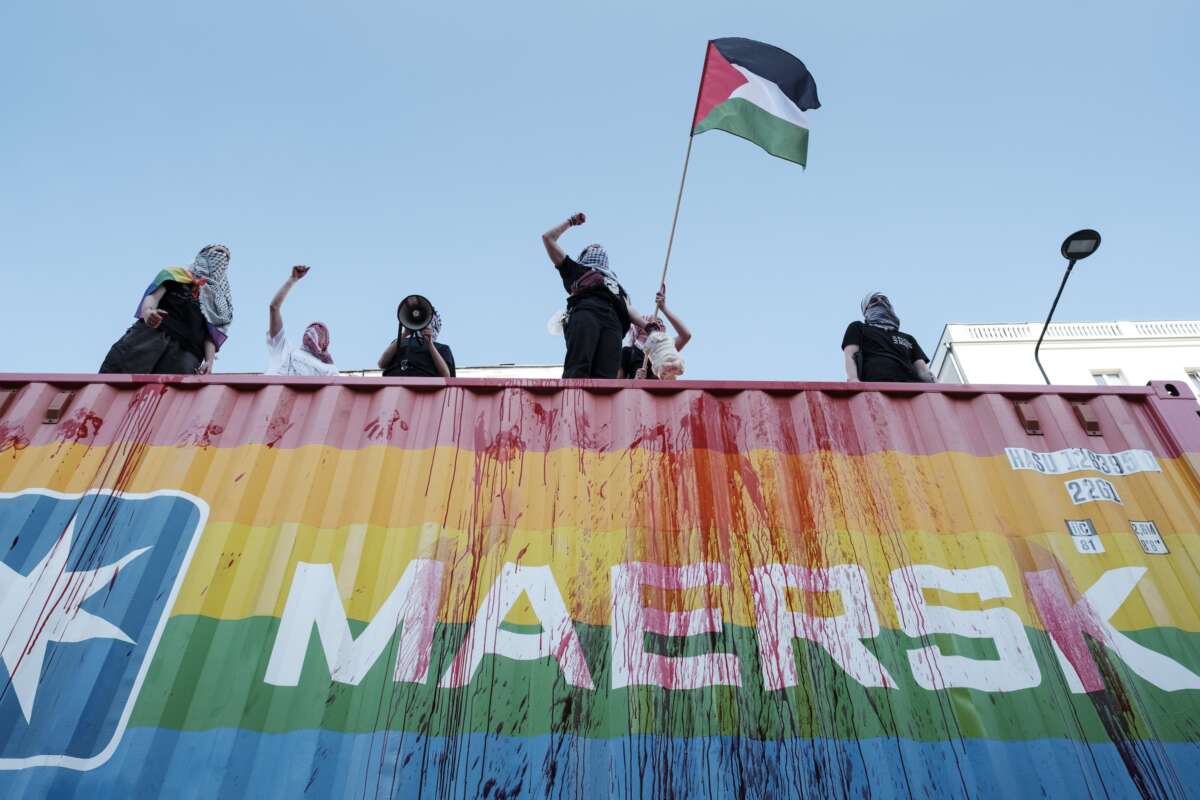 Pro-Palestinian protesters block a Maersk container during the Warsaw Equality Parade in Warsaw, Poland, on June 14, 2025, accusing the company of transporting arms for Israel.