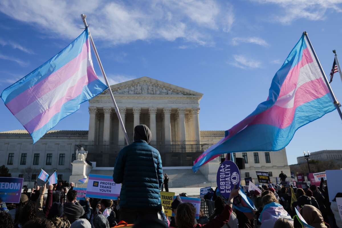Protesters supporting transgender athletes competing in women's sports gather outside the Supreme Court on January 13, 2026 in Washington, DC, while two cases that prohibit transgender girls from joining girls' and women's sports teams are heard inside the Supreme Court.