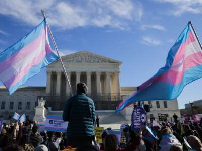 Protesters supporting transgender athletes competing in women's sports gather outside the Supreme Court on January 13, 2026 in Washington, DC, while two cases that prohibit transgender girls from joining girls' and women's sports teams are heard inside the Supreme Court.