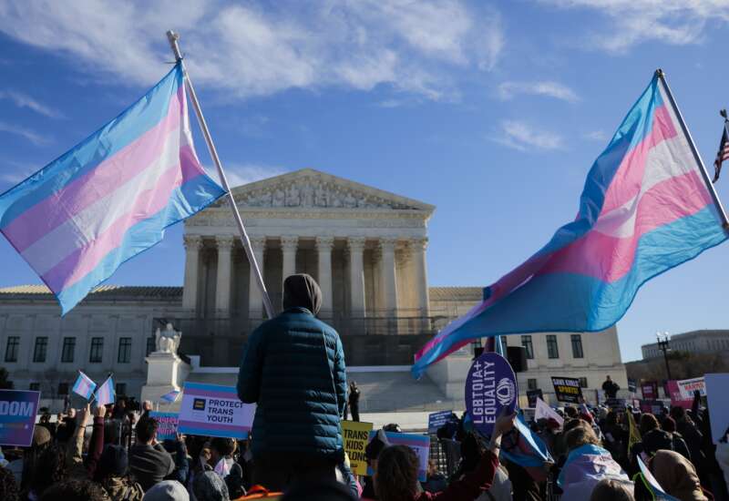 Protesters supporting transgender athletes competing in women's sports gather outside the Supreme Court on January 13, 2026 in Washington, DC, while two cases that prohibit transgender girls from joining girls' and women's sports teams are heard inside the Supreme Court.
