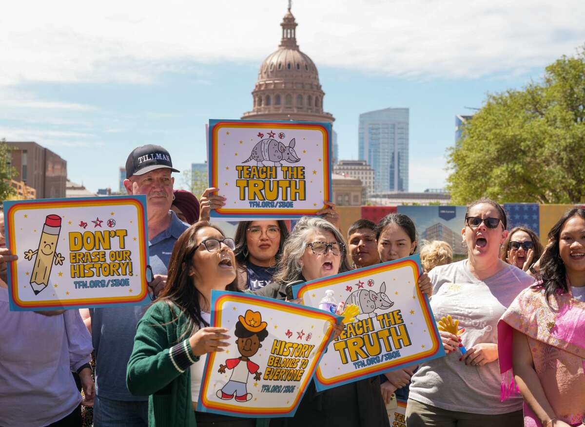 People hold signs reading "Teach the Truth" and "Don't erase our history" during a rally on the Capitol Mall where the State Board of Education meets, Tuesday, April 7, 2026, in Austin, Texas.