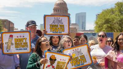 People hold signs reading "Teach the Truth" and "Don't erase our history" during a rally on the Capitol Mall where the State Board of Education meets, Tuesday, April 7, 2026, in Austin, Texas.
