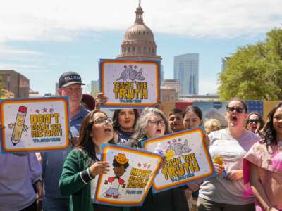 People hold signs reading "Teach the Truth" and "Don't erase our history" during a rally on the Capitol Mall where the State Board of Education meets, Tuesday, April 7, 2026, in Austin, Texas.