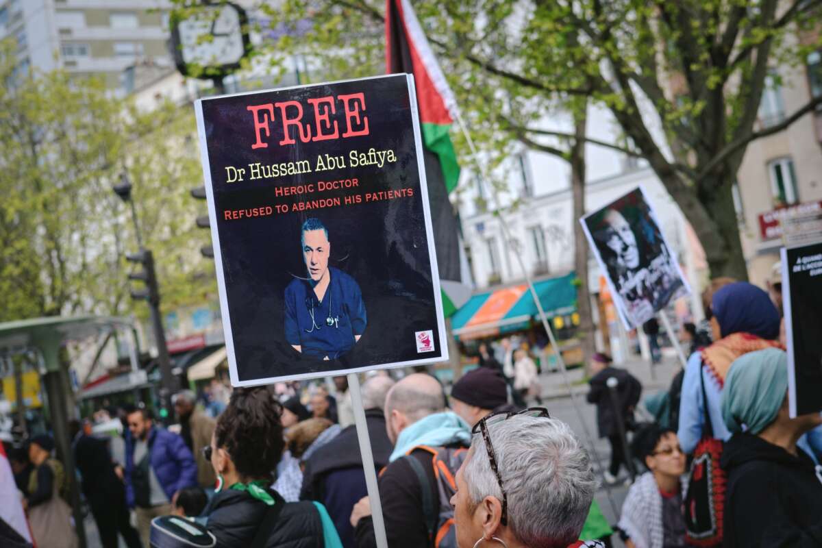 A protestor holds a sign reading Free Hussam Abu Safiya during a pro Palestine demonstration in Paris on April 18, 2026.