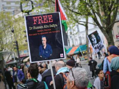 A protestor holds a sign reading Free Hussam Abu Safiya during a pro Palestine demonstration in Paris on April 18, 2026.