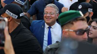 Israel's National Security Minister Itamar Ben Gvir takes part in the Jerusalem Day parade at the Damascus Gate in the old city of Jerusalem on May 14, 2026. Every year, thousands of Israeli nationalists march through Jerusalem and its occupied Old City, including in predominantly Palestinian neighborhoods, waving Israeli flags and shouting inflammatory slogans. Ben Gvir is shown wearing his noose pin celebrating Israel's new death penalty law against Palestinians.