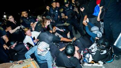 Newark Police clash with protesters as they try to block vehicles leaving Delaney Hall Immigration Detention Center on June 4, 2026 in Newark, New Jersey.