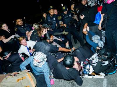 Newark Police clash with protesters as they try to block vehicles leaving Delaney Hall Immigration Detention Center on June 4, 2026 in Newark, New Jersey.