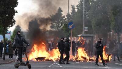 Masked young men set fires and targeted immigrants and people of color in Belfast, Northern Ireland, on June 9, 2026, after word of a knife attack circulated online along with right-wing calls that blamed migrants.