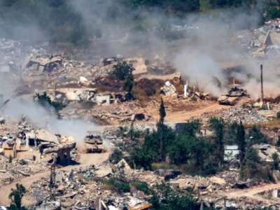 Israeli Merkava tanks drive along a road past destroyed buildings in southern Lebanon on June 17, 2026.