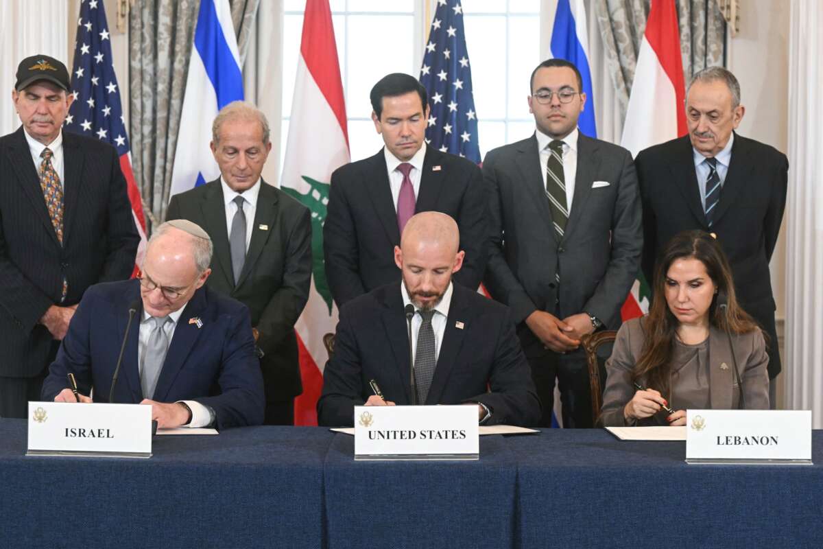 US Secretary of State Marco Rubio (C, back) looks on as (L/R, front row) Israeli Ambassador to the US Yechiel Leiter, State Department Chief of Staff Daniel Holler, and Lebanese Ambassador to the US Nada Hamadeh sign a framework agreement at the US Department of State in Washington, DC, on June 26, 2026.