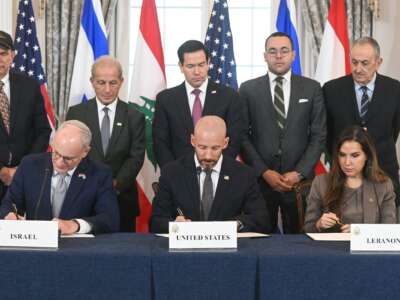 US Secretary of State Marco Rubio (C, back) looks on as (L/R, front row) Israeli Ambassador to the US Yechiel Leiter, State Department Chief of Staff Daniel Holler, and Lebanese Ambassador to the US Nada Hamadeh sign a framework agreement at the US Department of State in Washington, DC, on June 26, 2026.