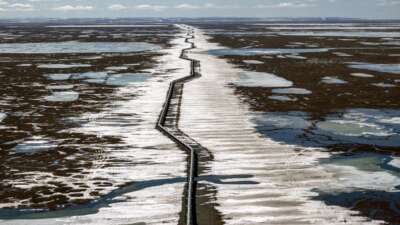 An oil pipeline stretches across the landscape outside Prudhoe Bay in North Slope Borough, Alaska, on May 25, 2019. The proposed Alaska LNG megaproject includes an 800-mile fossil gas pipeline running from the North Slope to a processing plant and export terminal in the Cook Inlet that would damage permafrost and disrupt caribou migration routes.