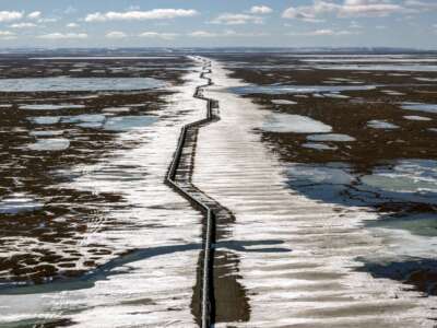 An oil pipeline stretches across the landscape outside Prudhoe Bay in North Slope Borough, Alaska, on May 25, 2019. The proposed Alaska LNG megaproject includes an 800-mile fossil gas pipeline running from the North Slope to a processing plant and export terminal in the Cook Inlet that would damage permafrost and disrupt caribou migration routes.
