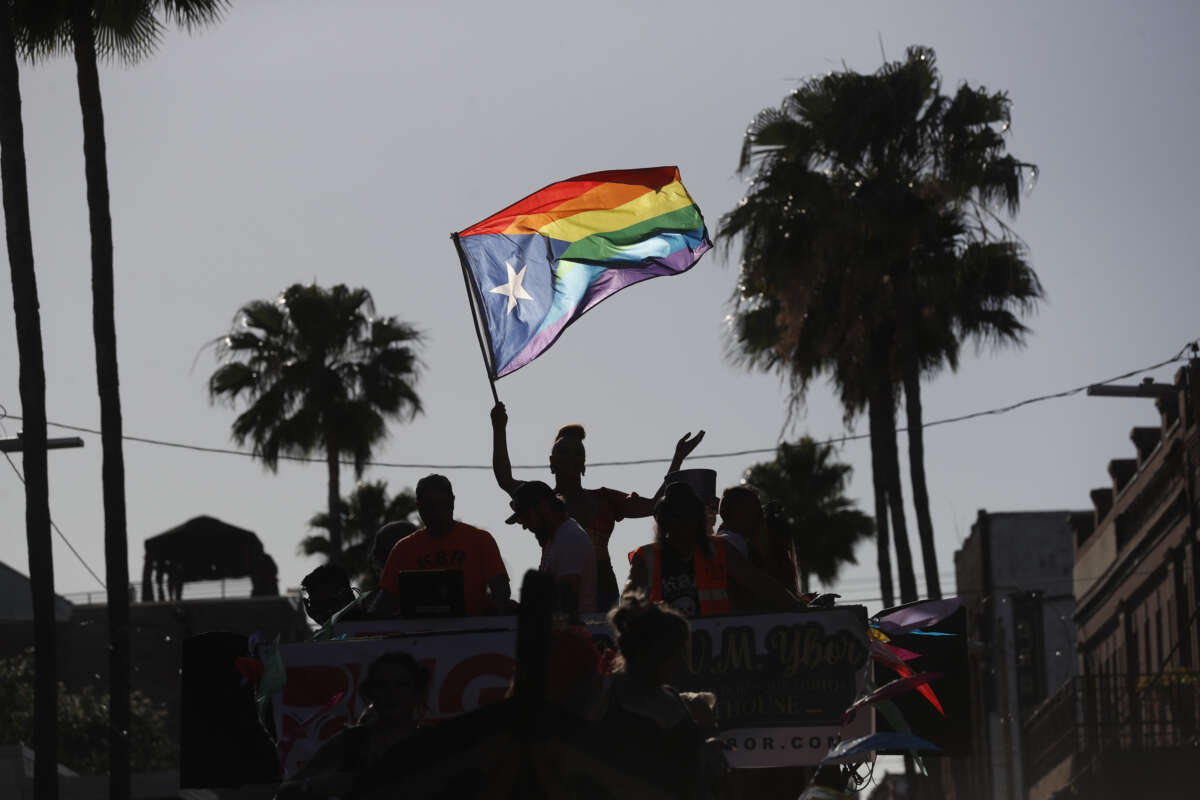 Revelers celebrate on 7th Avenue during the Tampa Pride Parade in the Ybor City neighborhood on March 26, 2022, in Tampa, Florida. The Tampa Pride was held in the wake of the passage of Florida's controversial "Don't Say Gay" Bill.