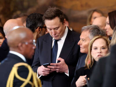 SpaceX, X, and Tesla CEO Elon Musk looks at his phone during the inauguration of Donald Trump as the 47th president of the United States in the Rotunda of the U.S. Capitol in Washington, D.C., on January 20, 2025.