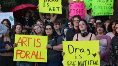 Attendees hold signs during a protest sponsored by Texas A&M University Queer Empowerment Council's Day of Drag protest on campus in College Station, Texas, on March 6, 2025. The protest was against the school system's recent ban on drag shows at university event spaces.