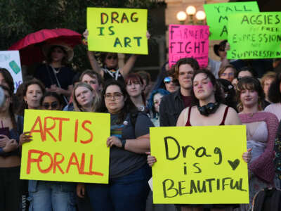 Attendees hold signs during a protest sponsored by Texas A&M University Queer Empowerment Council's Day of Drag protest on campus in College Station, Texas, on March 6, 2025. The protest was against the school system's recent ban on drag shows at university event spaces.