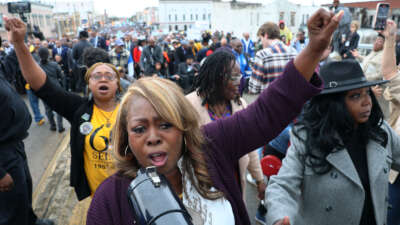 LaTosha Brown, co-founder of the voting rights group Black Voters Matter, leads people in a chant as they walk across Edmund Pettus Bridge as they commemorate the 60th anniversary of "Bloody Sunday" on March 9, 2025, in Selma, Alabama.