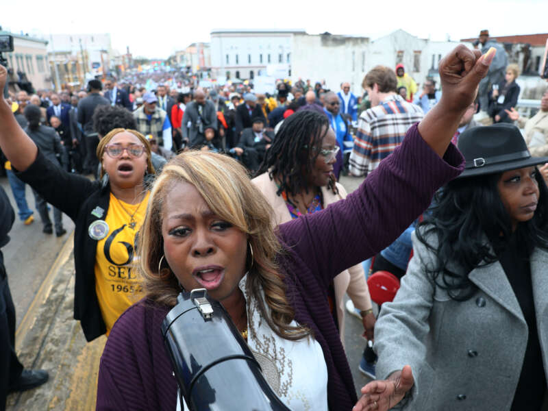 LaTosha Brown, co-founder of the voting rights group Black Voters Matter, leads people in a chant as they walk across Edmund Pettus Bridge as they commemorate the 60th anniversary of "Bloody Sunday" on March 9, 2025, in Selma, Alabama.