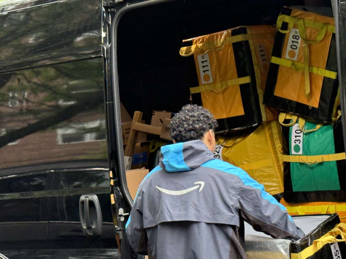 Amazon delivery person sorting packages to be delivered in New York City.