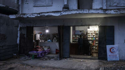 Men stand at the counter of a pharmacy in the Al-Saftawi neighborhood, west of Jabalia city in the northern Gaza Strip on December 10, 2025.