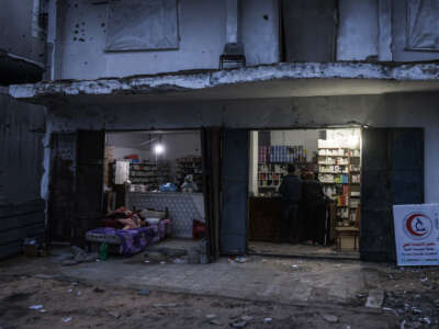 Men stand at the counter of a pharmacy in the Al-Saftawi neighborhood, west of Jabalia city in the northern Gaza Strip on December 10, 2025.