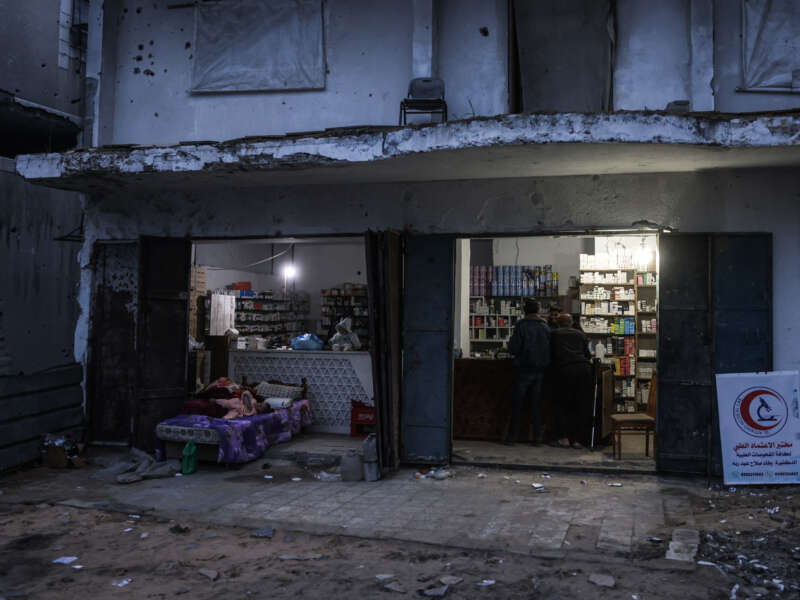 Men stand at the counter of a pharmacy in the Al-Saftawi neighborhood, west of Jabalia city in the northern Gaza Strip on December 10, 2025.