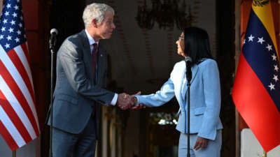 U.S. Secretary of Energy Chris Wright shakes hands with Venezuela's Acting President Delcy Rodriguez during a press conference after a meeting at the Miraflores Presidential Palace in Caracas, Venezuela, on February 11, 2026.