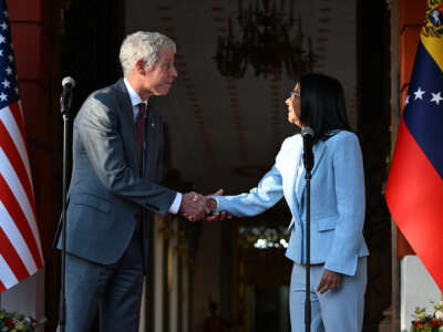 U.S. Secretary of Energy Chris Wright shakes hands with Venezuela's Acting President Delcy Rodriguez during a press conference after a meeting at the Miraflores Presidential Palace in Caracas, Venezuela, on February 11, 2026.
