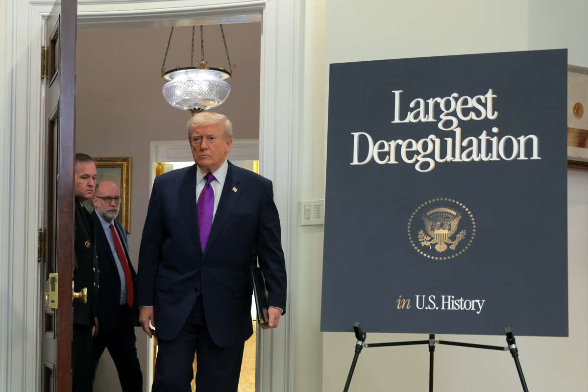 Donald Trump arrives at an event to announce a rollback of the 2009 Endangerment Finding in the Roosevelt Room at the White House on February 12, 2026, in Washington, D.C. The Trump administration repealed the 2009 central scientific finding that allows the EPA to regulate climate-warming emissions.
