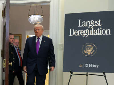 Donald Trump arrives at an event to announce a rollback of the 2009 Endangerment Finding in the Roosevelt Room at the White House on February 12, 2026, in Washington, D.C. The Trump administration repealed the 2009 central scientific finding that allows the EPA to regulate climate-warming emissions.